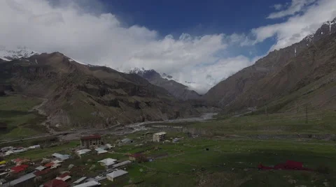 Mountains and small town aerial view Stock Footage 64877448