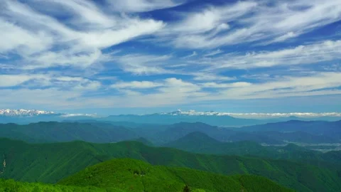 The Mountains and Stratus Clouds Viewed from the Fresh Green Beauty of the Stock Footage 333178018