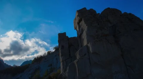 Mountains and valleys time lapse of puffy white clouds, blue skies and cloud sha Stock Footage 53124228