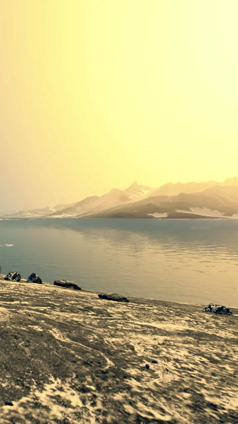 Mountains and water under a bright sky during sunset Stock Footage 346758833