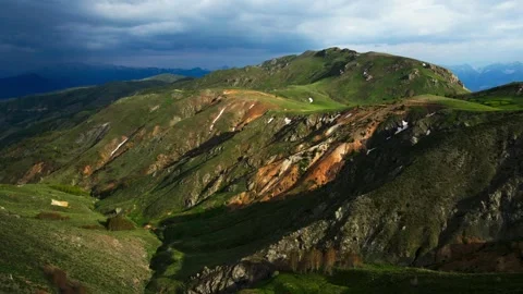 The mountains are covered in green grass and rocks Stock Footage 327923751