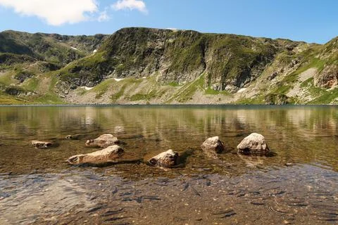 The mountains are reflecting on the smooth surface of the Kidney, Babreka Lak Stock Photos