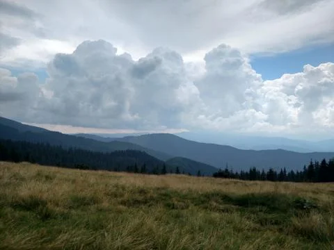 Mountains ate clouds and lawn Grassland with dry grass Stock Photos