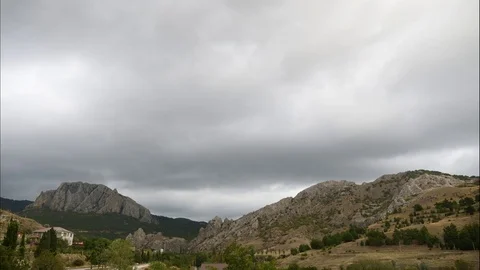 Mountains in the background of gray clouds. Dark clouds envelop the tops of the Stock Footage 97185517