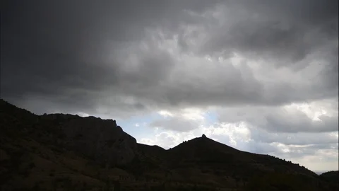 Mountains in the background of gray clouds. Dark clouds envelop the tops of the Stock Footage 97256743