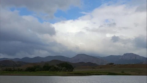 Mountains in the background of gray clouds. Dark clouds envelop the tops of the Stock Footage 97464210