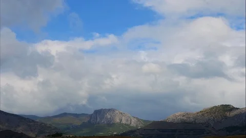 Mountains in the background of gray clouds. Dark clouds envelop the tops of the Stock Footage 97464389