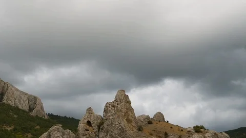 Mountains in the background of gray clouds. Dark clouds envelop the tops of the Stock Footage 98463424