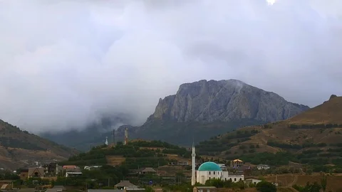 Mountains in the background of gray clouds. Dark clouds envelop the tops of the Stock Footage 98551530