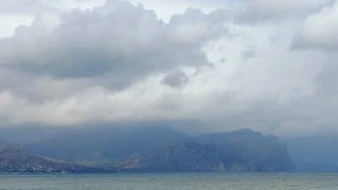 Mountains in the background of gray clouds. Dark clouds envelop the tops of the Stock Footage 99365081