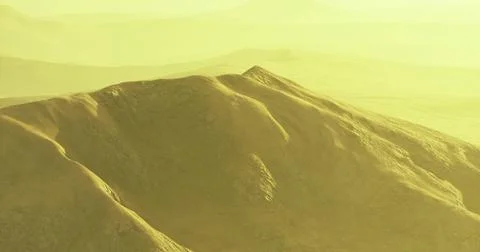 Mountains bathed in yellow light under a hazy sky during sunset Stock Illustration