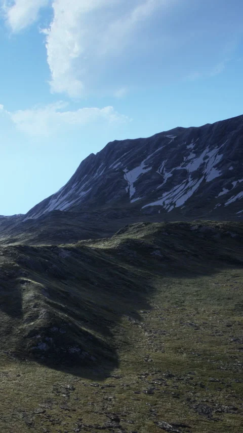 Mountains in clear sky with snow on peaks and green valley below in daylight Stock Footage 340633432