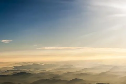 Mountains clouds blue sky and fog photographed from on mountaintop Stock Photos