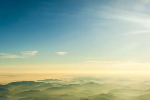 Mountains clouds blue sky and fog photographed from on mountaintop Stock Photos