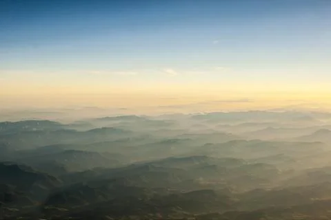 Mountains clouds blue sky and fog photographed from on mountaintop Stock Photos