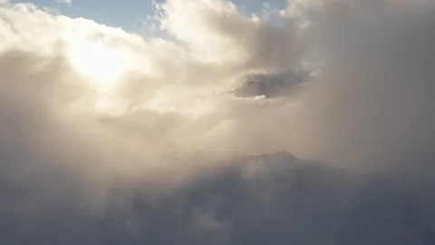 Mountains in Clouds Drone Austria Alps Switzerland Summit Golden Hour Stock Footage 169893970