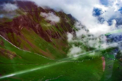 Mountains in the clouds, mountain stream. View from ski lift Stock Photos