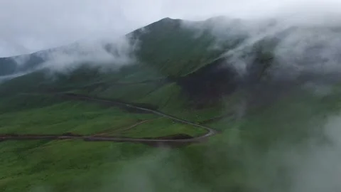 Mountains in clouds, View from drone above clouds of mountain village Video stock 237774762