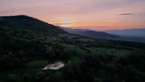 Mountains covered with forest and lake at sunset, aerial view, direct flight Stock Footage 274488271