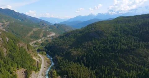 Mountains covered in forest, a river and Sea to Sky Highway between them. Canada Stockbeeldmateriaal 343448465