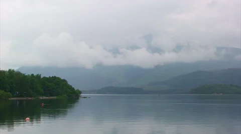 Mountains covered by low cloud over Loch Lomond Stock Footage