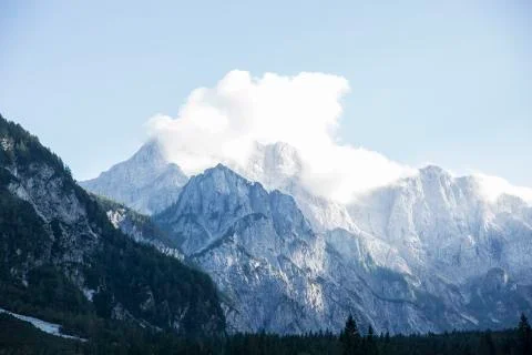 Mountains covered with white clouds under blue sky from Planica Stock Photos