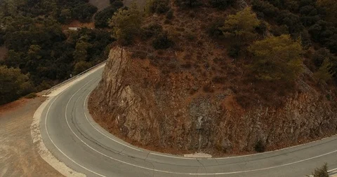 Mountains of cyprus. view from above. Mountain road. the car leaves behind a sha Stock Footage 97299462