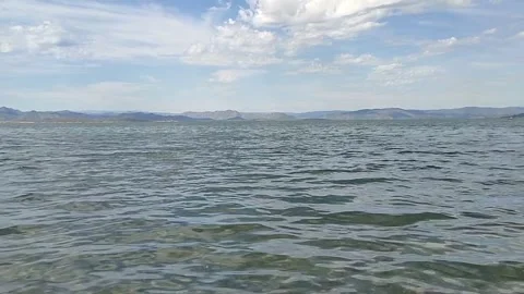 Mountains in the distance. Clouds. Stones at the bottom of the water. Stock Footage 335458703