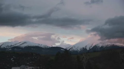 Mountains during cloudy, colorful sunset Stock Footage 239255354