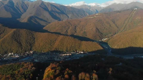 Mountains in early spring. Aero view of the village between the high mountains Stock Footage 171566050