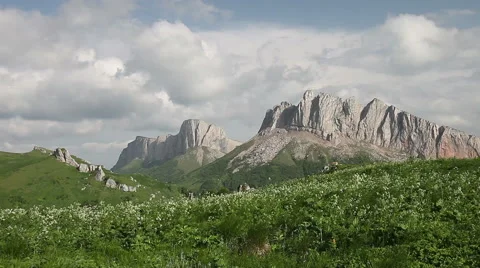 Mountains (Eastern and Western Acheshbok) under a blue sky with clouds Video stock 64821049