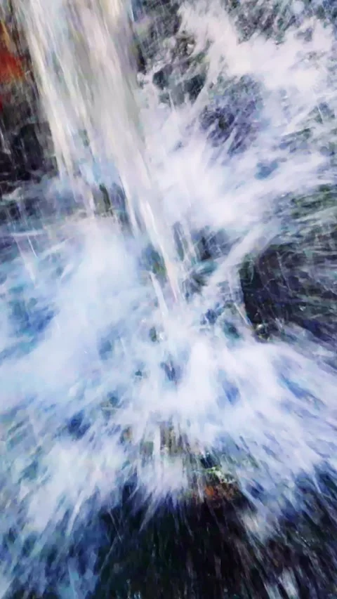 In the mountains, an ecological gem thrives, a small, crystal clear waterfall, a Stock Footage 254618365