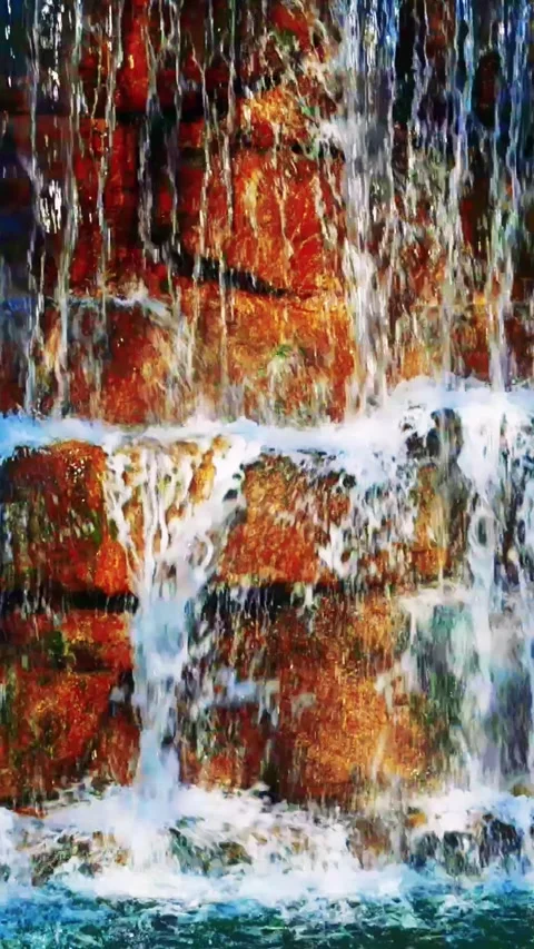 In the mountains, an ecological gem thrives, a small, crystal clear waterfall, a Stock Footage 254618381