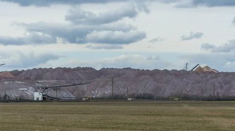 Mountains of empty ore when mining potassium. Transportation of an empty rock Stock Photos