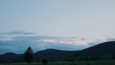 Mountains forest landscape under evening blue sky with clouds in sunlight Stock Footage 199673483