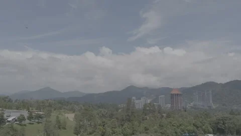 Mountains, forests, and buildings under an overcast sky. Video stock 341849087