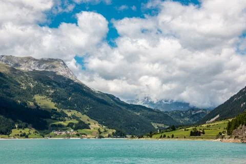 The mountains, green fields, meadows and forests near by the lake Stock Photos