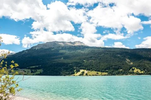 The mountains, green fields, meadows and forests near by the lake Stock Photos