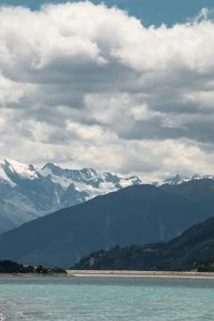 The mountains, green fields, meadows and forests near by the lake Фото