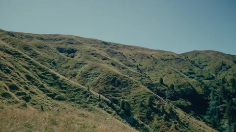 Mountains with Green Grass Slopes Under Clear Blue Sky in Summer Season 库存影片 331174662