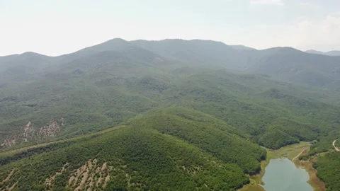 Mountains in greenery and a lake view from the air. Stock Footage 159119652