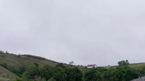 Mountains with greenery partially covered by clouds Stock Photos