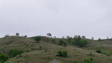 Mountains with greenery partially covered by clouds Stock Photos
