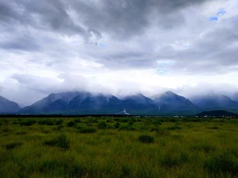 Mountains hidden in the clouds in the valley Stock Photos