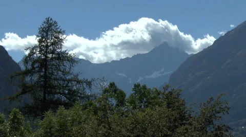 Mountains with Hugging Clouds Behind Trees and Green Shrubbery 動画素材 32269144