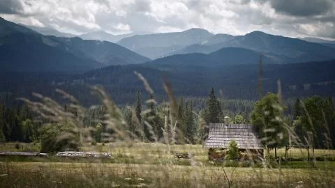 Mountains with the hut. Grass on the first plan  Stock Photos