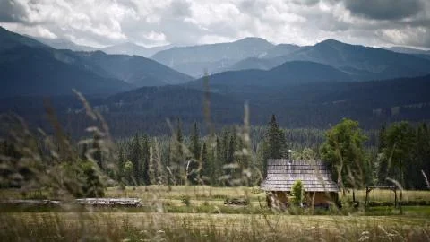 Mountains with the hut. Grass on the first plan  Stock Photos