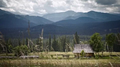 Mountains with the hut. Grass on the first plan  Stock Photos