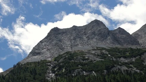 Mountains infront of blue sky and clouds in alps Stock Footage 90287404