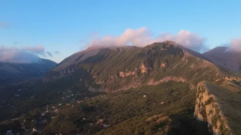 Mountains Loom Over a Valley as Clouds Pass by in the Late Afternoon in Italy Stock Footage 322934673